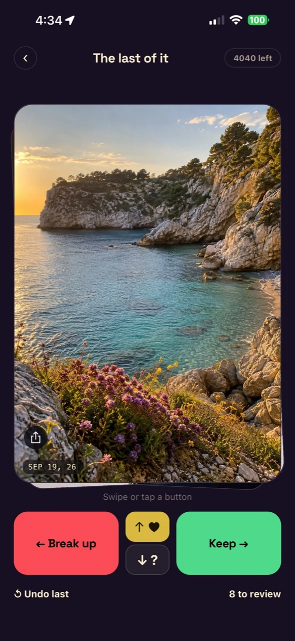 The app displaying a coastal memory ready to sort, with the original photo date and review controls.